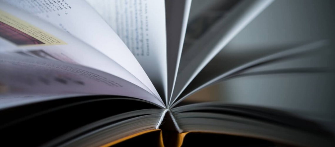 Close up of opened book on wooden table. Education concept. Close up of opened book on wooden table. Education concept.